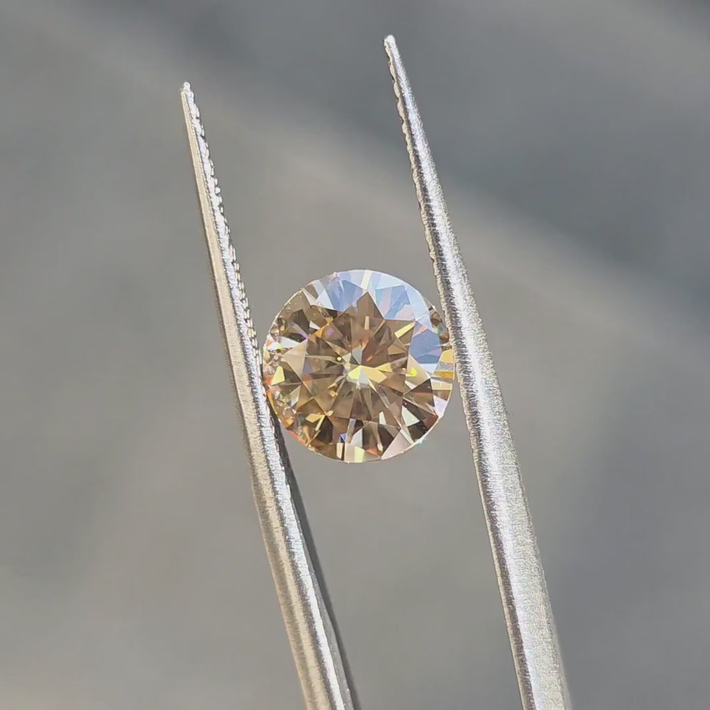 Doveggs champagne moissanite shining brightly in the sun