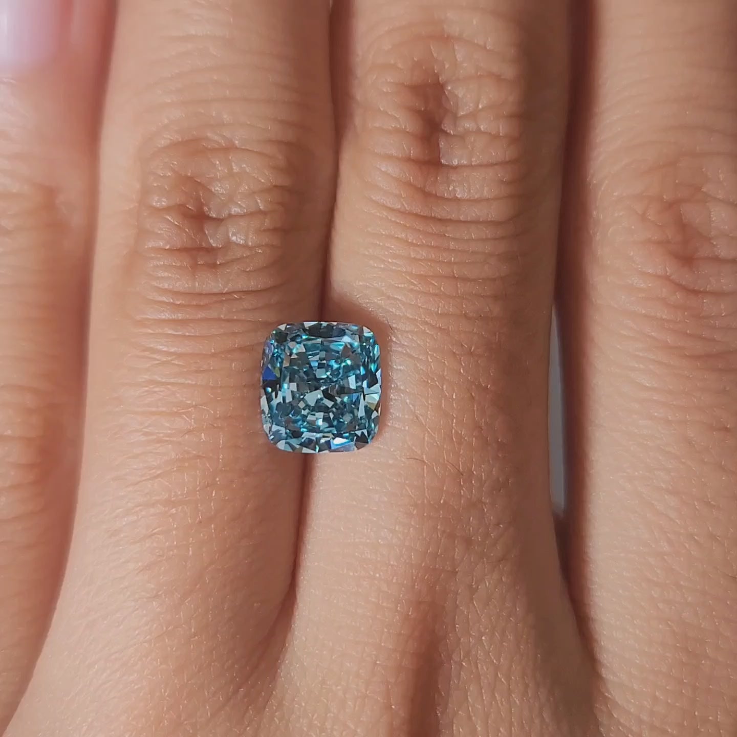 "Hand-modeled video showcasing 2.18ct bluish green cushion diamond"