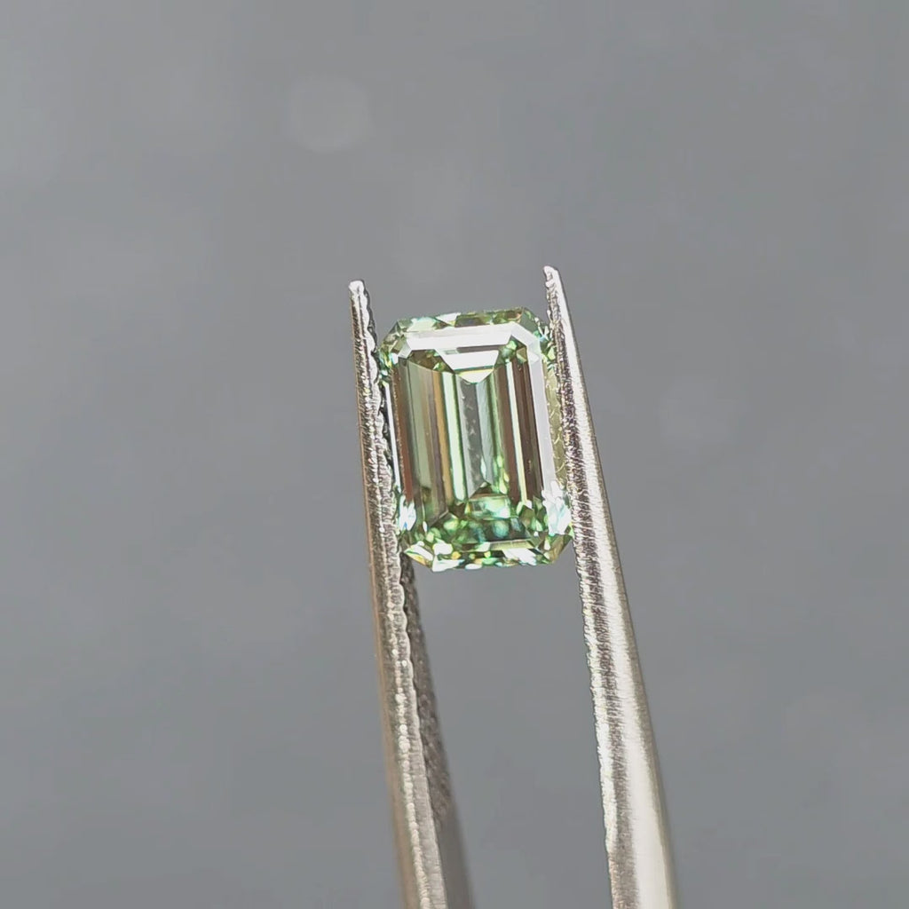 2.02ct emerald cut fancy vivid green VVS1 lab diamond sparkling in outdoor sunlight.