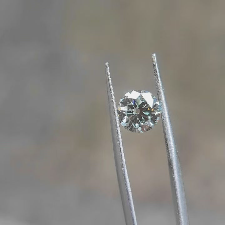 "1.53ct Old euro cut  round lab grown diamond with emerald-green flashes and antique faceting under sunlight video"