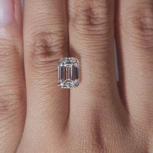 Close-up slow motion of 3.17ct emerald cut diamond's VVS1 clarity under warm light