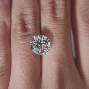 "Hand-modeled video of 3.690ct octagon diamond in warm indoor lighting"