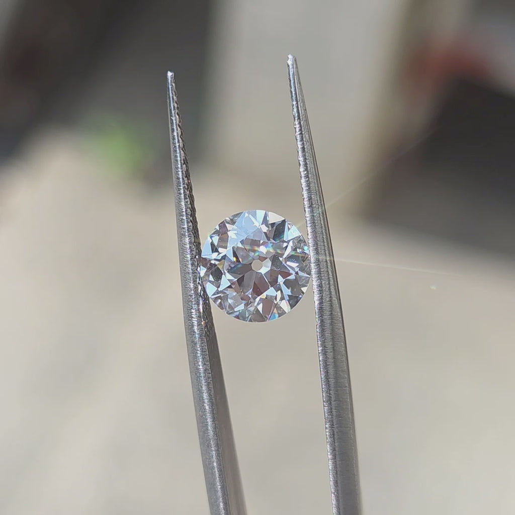 2.10ct round European cut D color VVS1 lab diamond showing exceptional brilliance in outdoor sunlight.