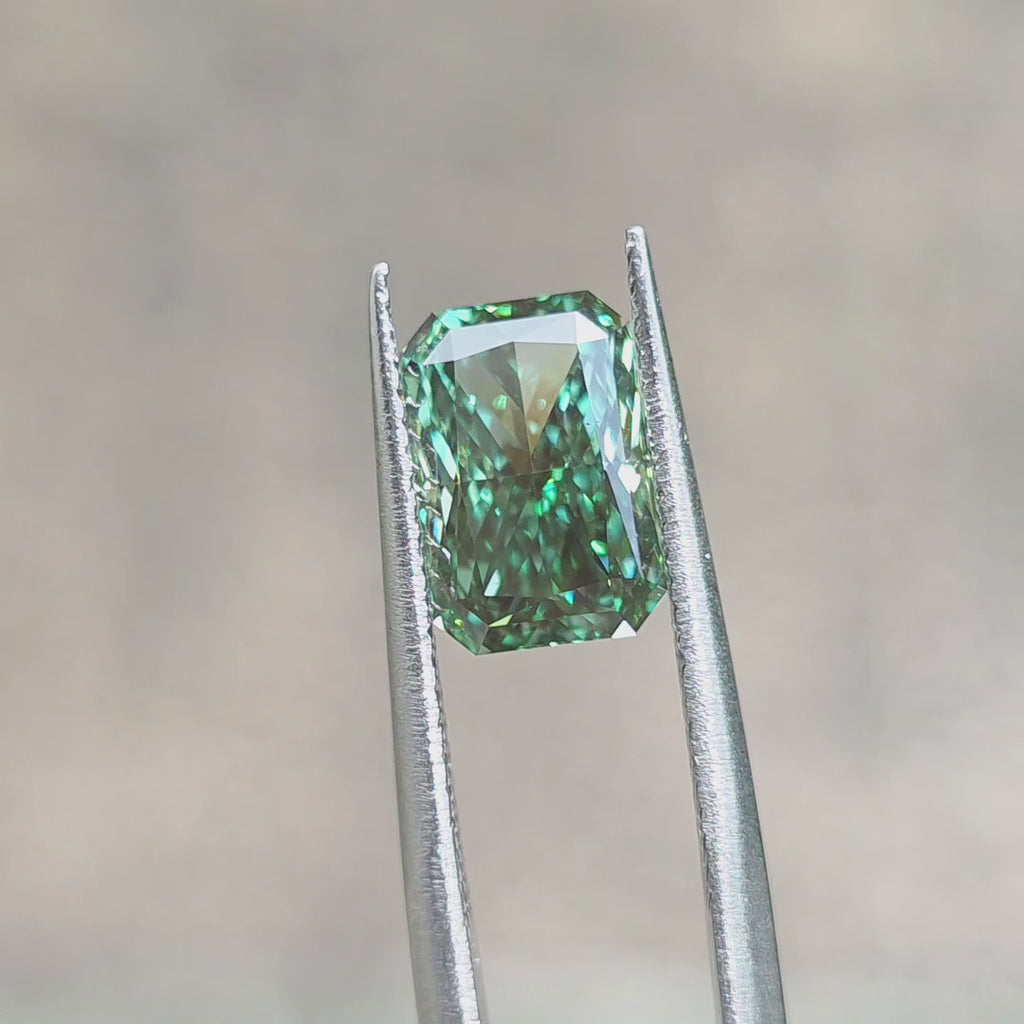 Lab diamond 2.65ct radiant brilliant cut fancy deep green VS1 by DovEggs displaying rich green hue in outdoor sunlight.