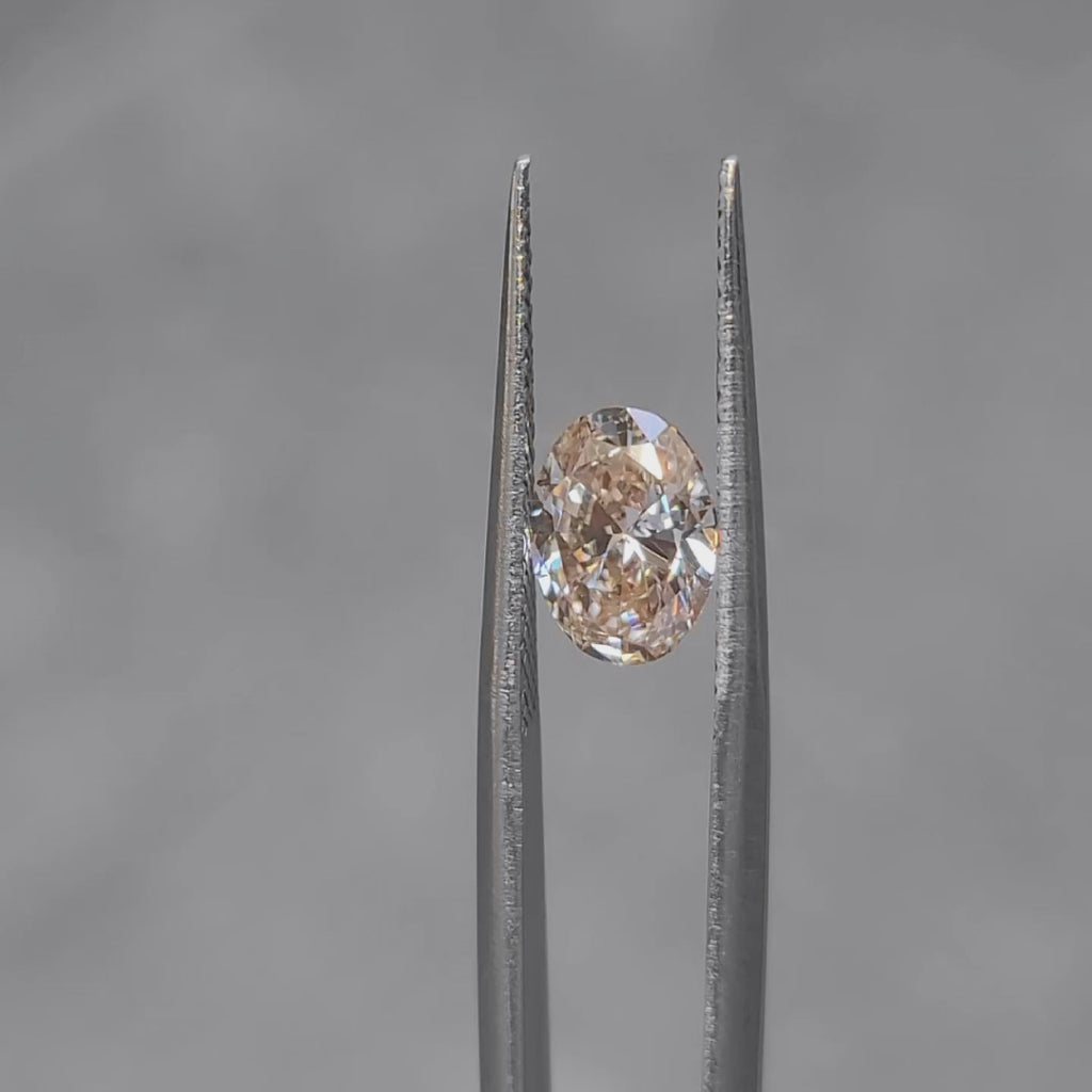 Outdoor video of 1.509ct oval Fancy Pink diamond's sparkle in sunlight