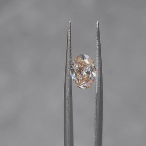 Outdoor video of 1.509ct oval Fancy Pink diamond's sparkle in sunlight
