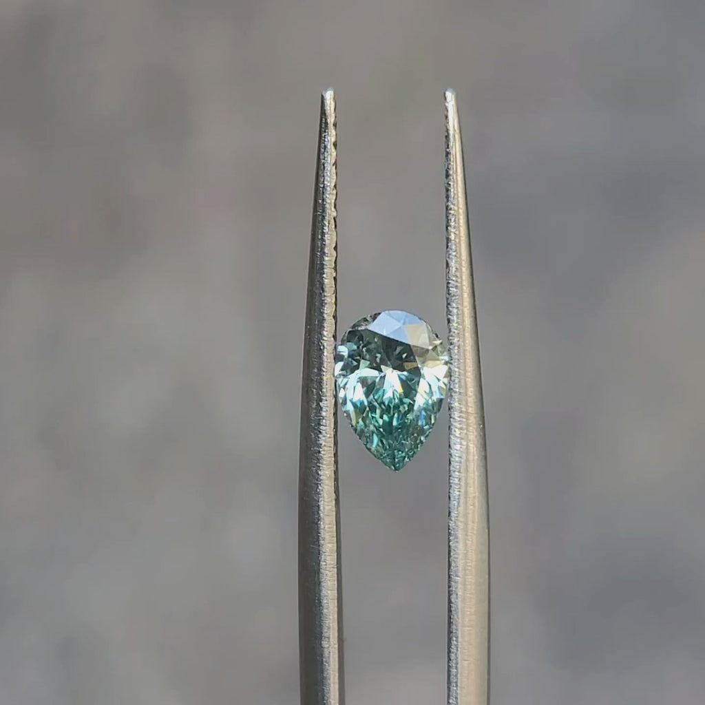 "Sunlight video showing 0.840ct pear cut fancy vivid green diamond's vibrant hue"
