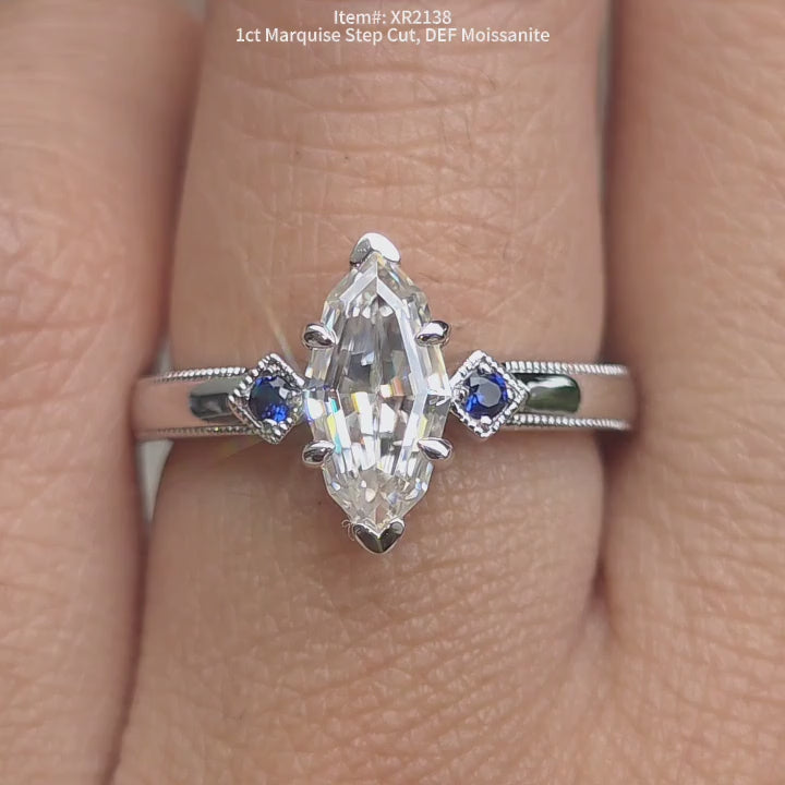 DovEggs marquise step cut moissanite ring | with blue sapphire side stones sparkling for women.