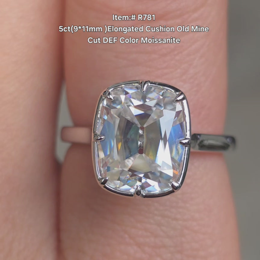 DovEggs elongated cushion old mine cur DEF color moissanite ring sparkling in sunlight video.