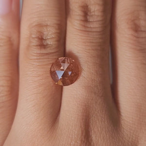 "Hand-modeled video of 2.53ct pink rose cut diamond in warm indoor lighting"