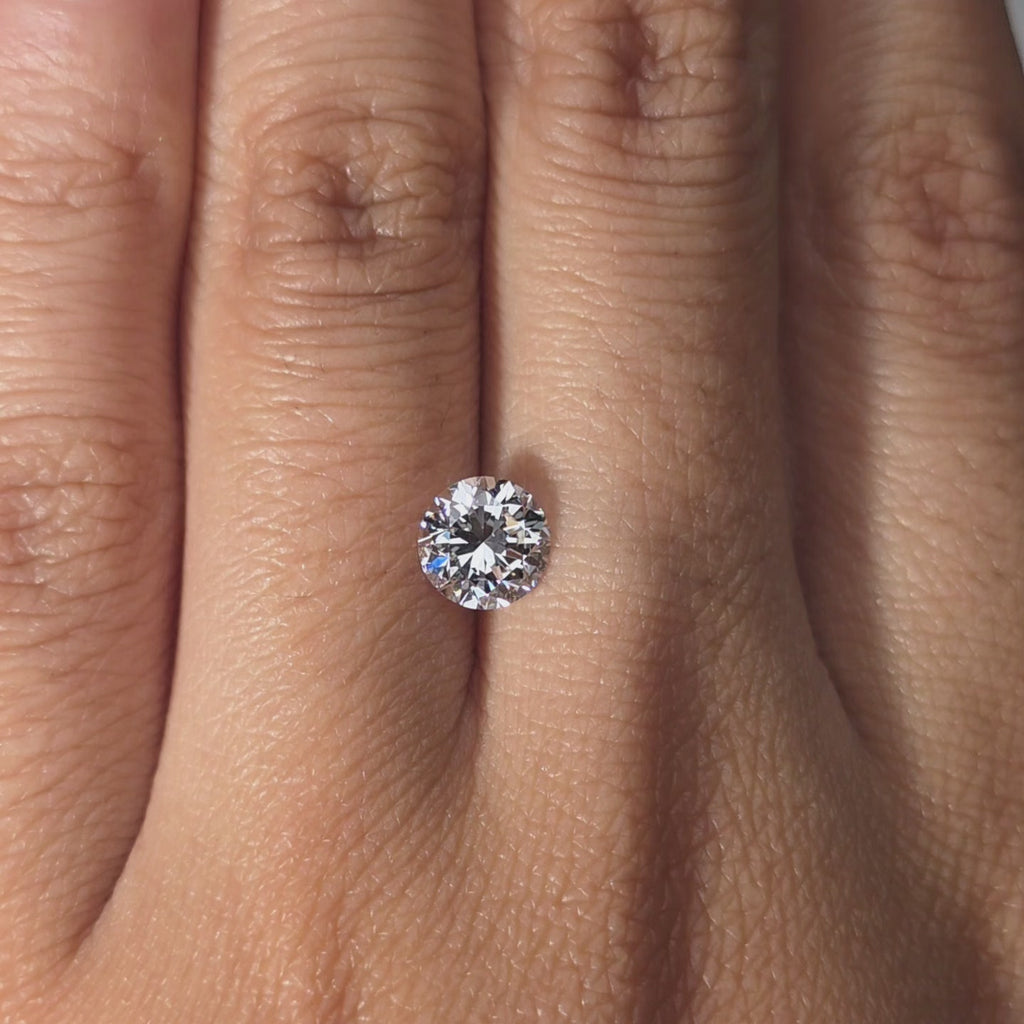 A 1.07ct Crown Arrow Cut™ lab diamond modeled in hand, warm indoor lighting.