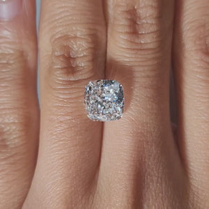 "Hand-modeled video of 3.73ct cushion diamond in warm indoor lighting"