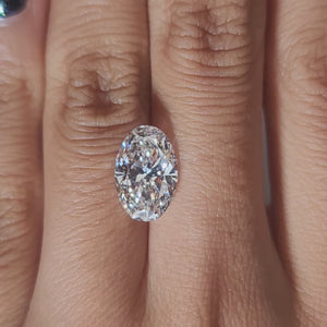 Hand-modeled video of 3.562ct oval E color diamond in warm indoor lighting