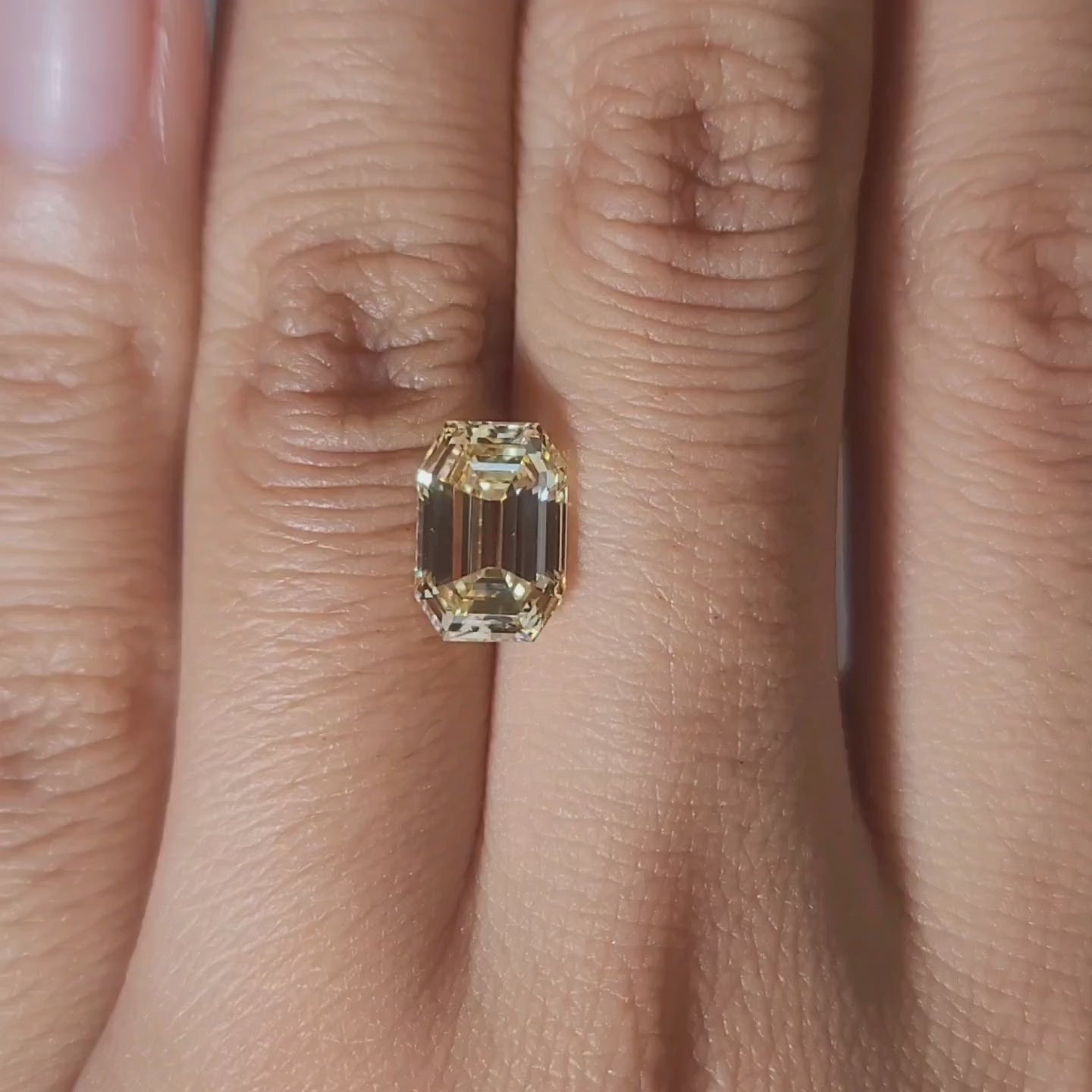 2.48ct Emerald yellow diamond in warm handheld lighting