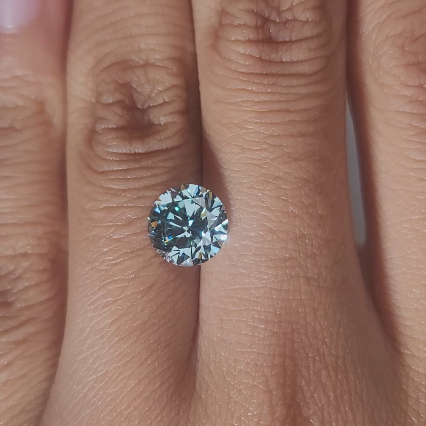 Close-up video of 2.160ct Round lab diamond under warm indoor lighting
