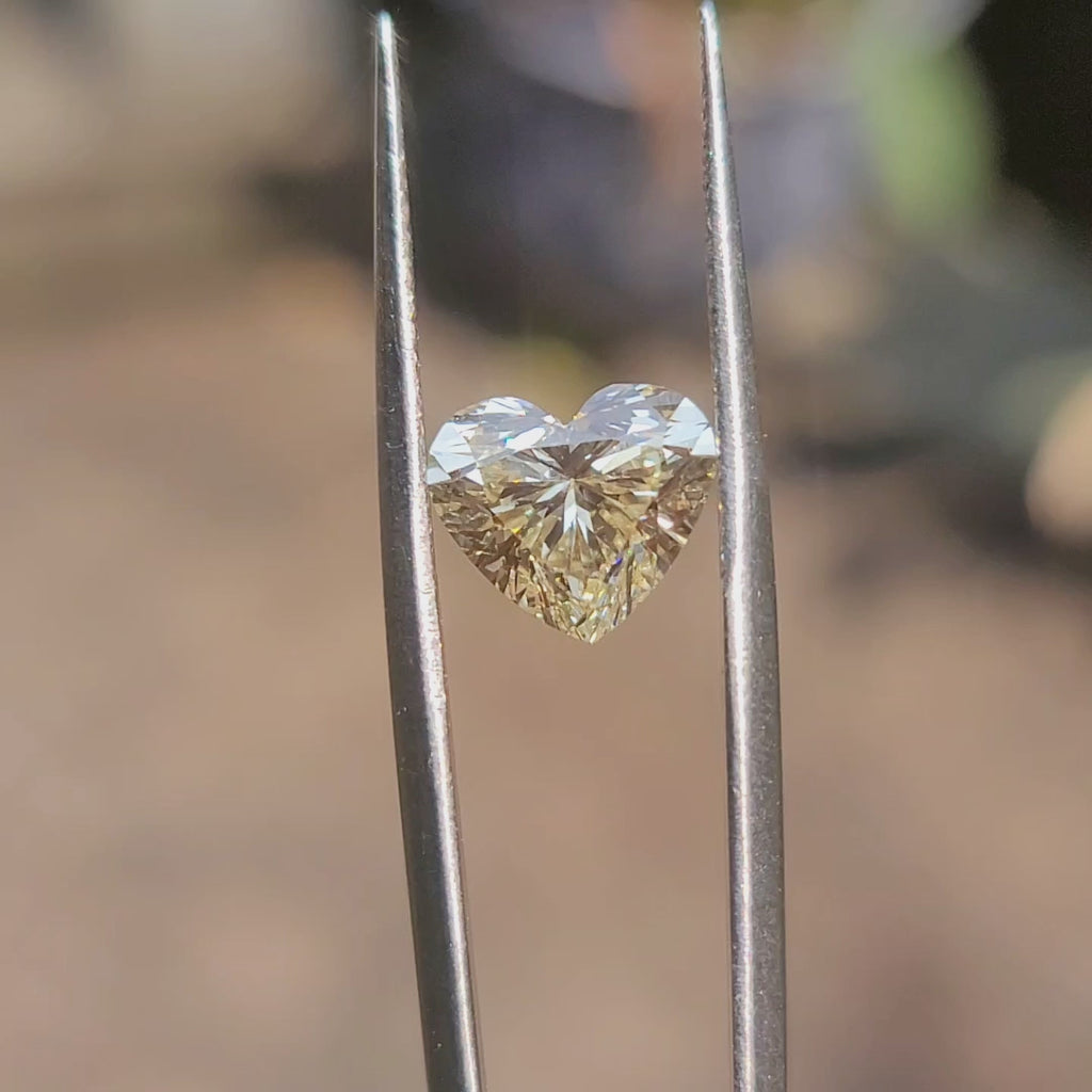 Sunlight video showing 3.07ct heart cut yellow diamond's intense color saturation