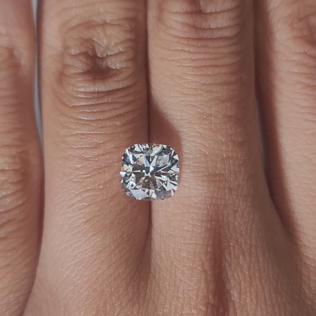 Hand-modeled video of 2.102ct cushion diamond in warm interior lighting
