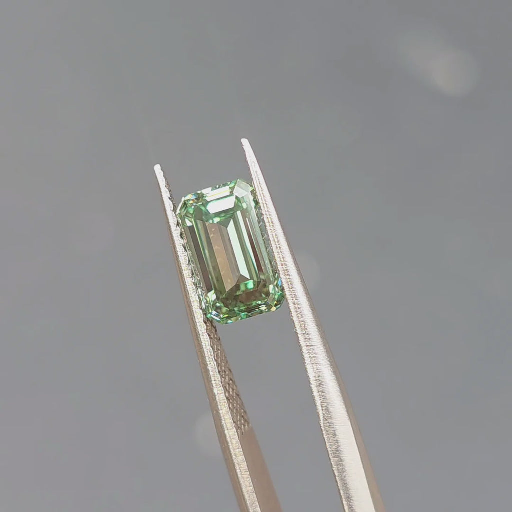 2.52ct emerald cut fancy vivid green VVS1 lab diamond sparkling under outdoor sunlight.