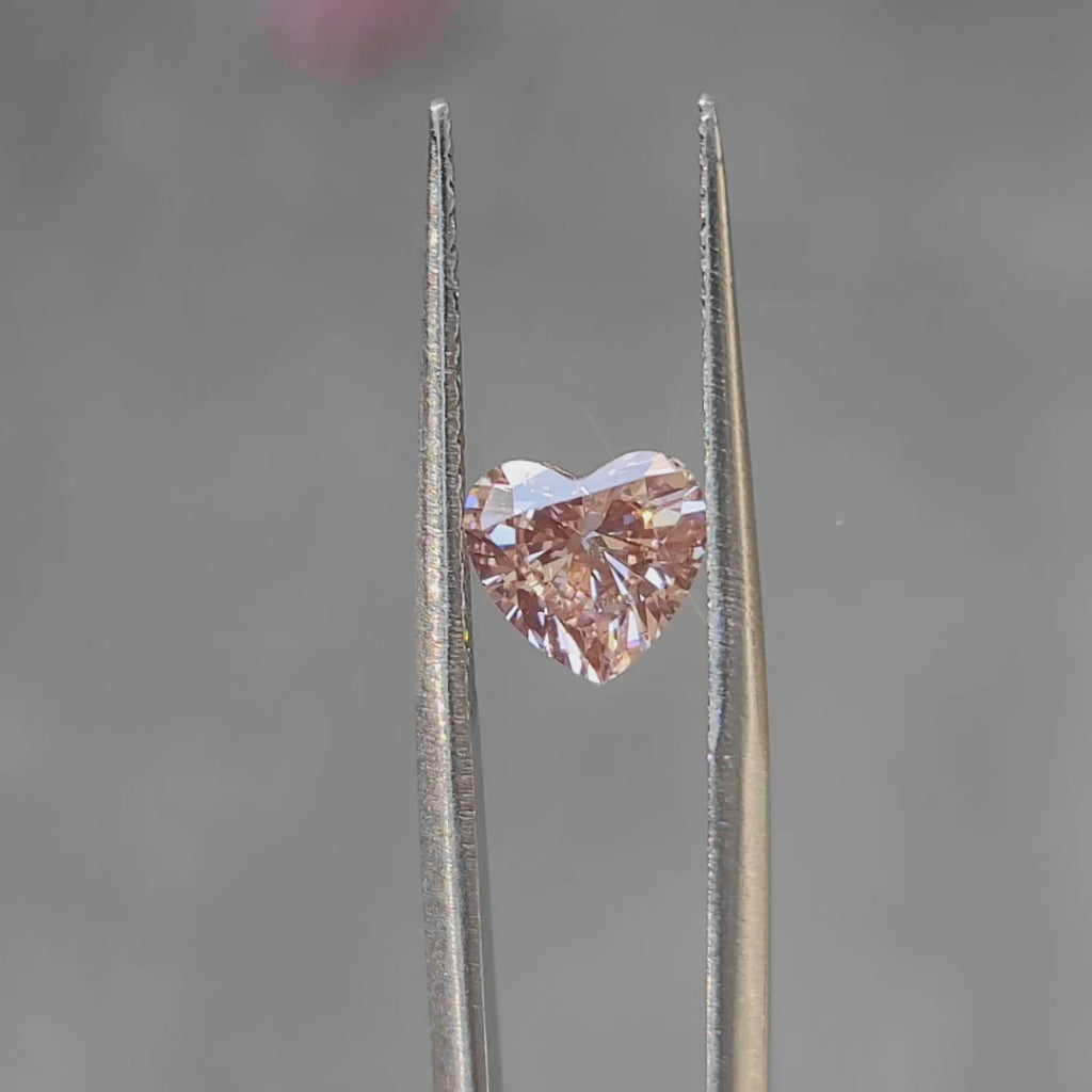 "Sunlight video showing 1.435ct heart cut fancy pink diamond's romantic color"