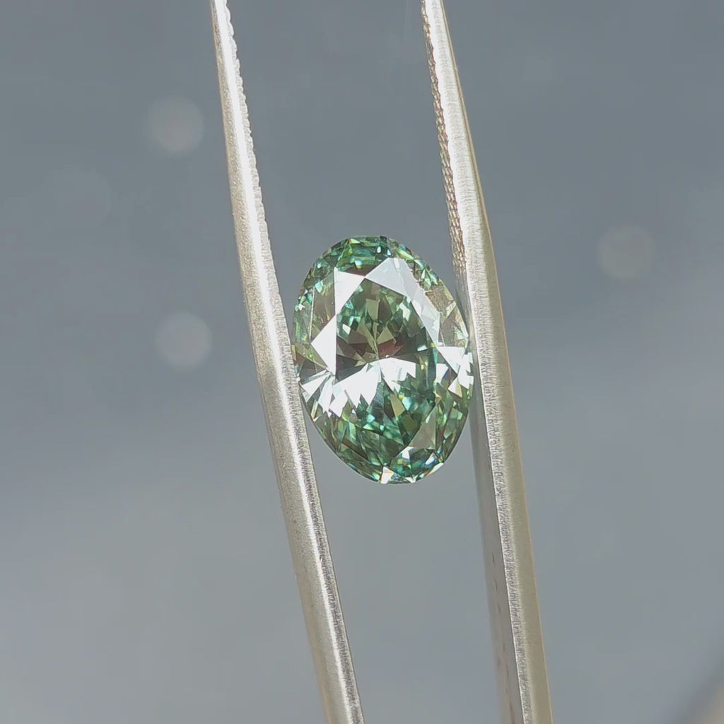 5.00ct oval brilliant cut fancy deep green VS1 lab diamond sparkling under outdoor sunlight.