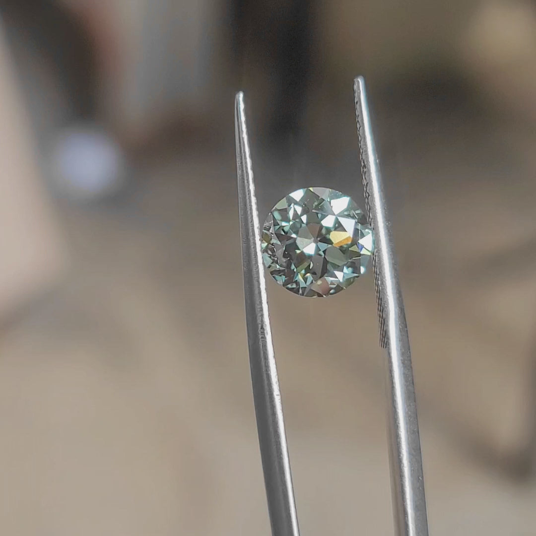 Outdoor video of 2.08ct old Euro cut round lab diamond with forest green color in natural light"