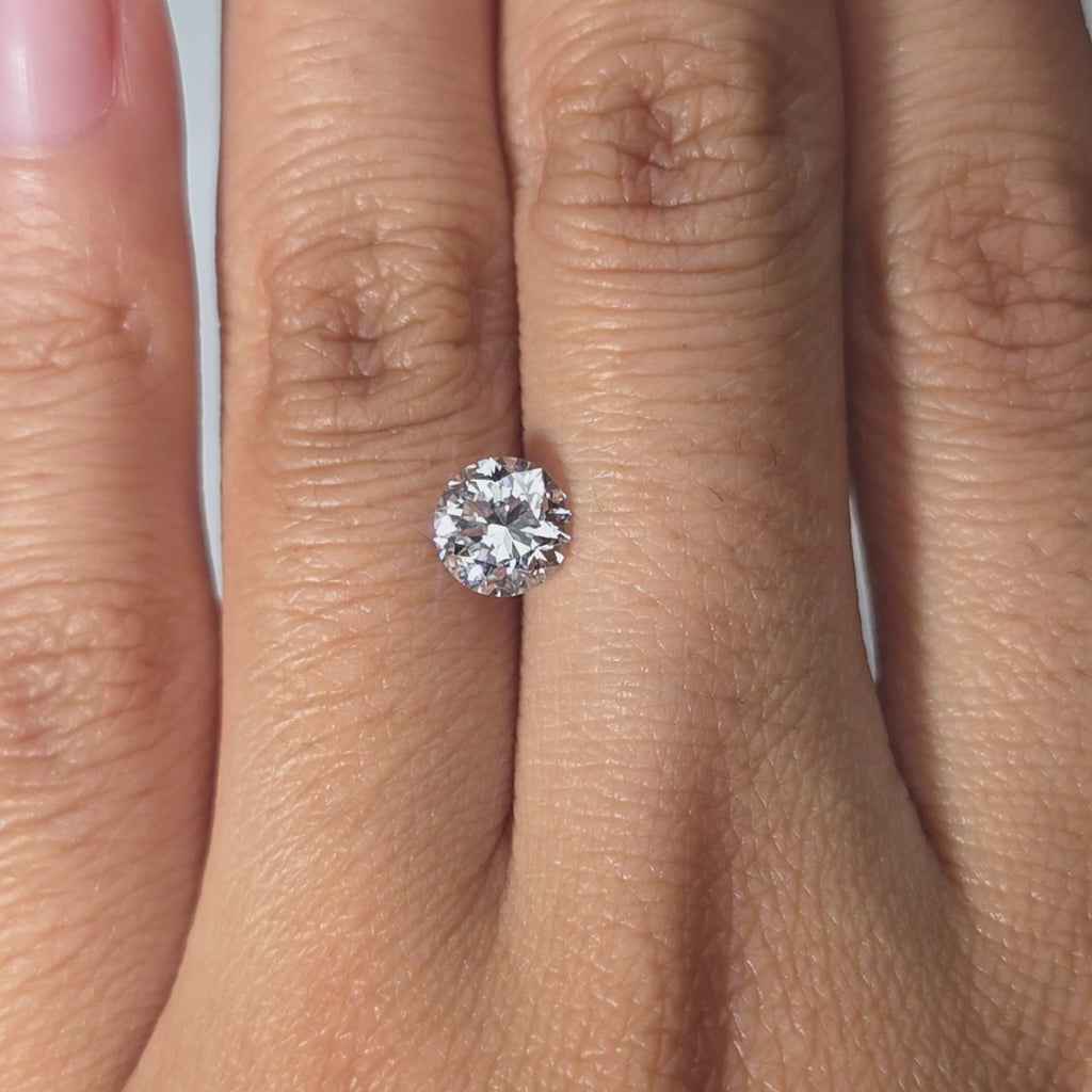 A hand presents a 1.08ct Crown Arrow Cut™ lab diamond in warm light.