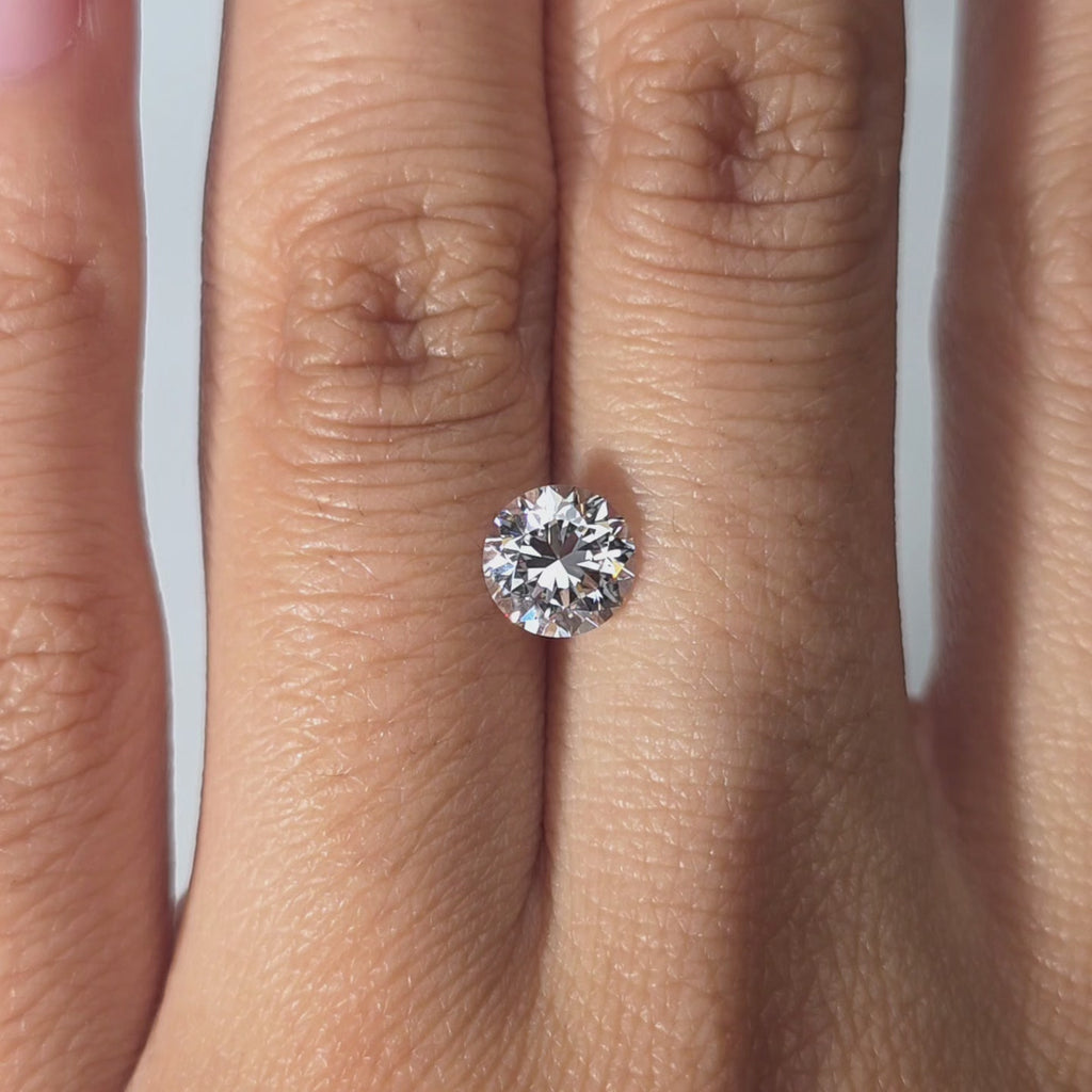 A 1.06ct Crown Arrow Cut™ lab diamond displayed in hand under warm light.