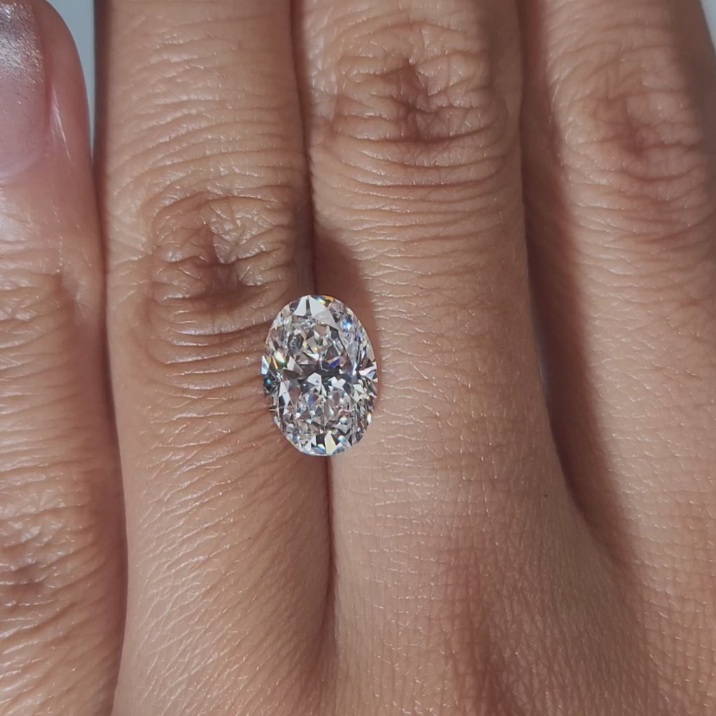 "Hand-modeled video of 2.540ct oval diamond in warm indoor lighting"