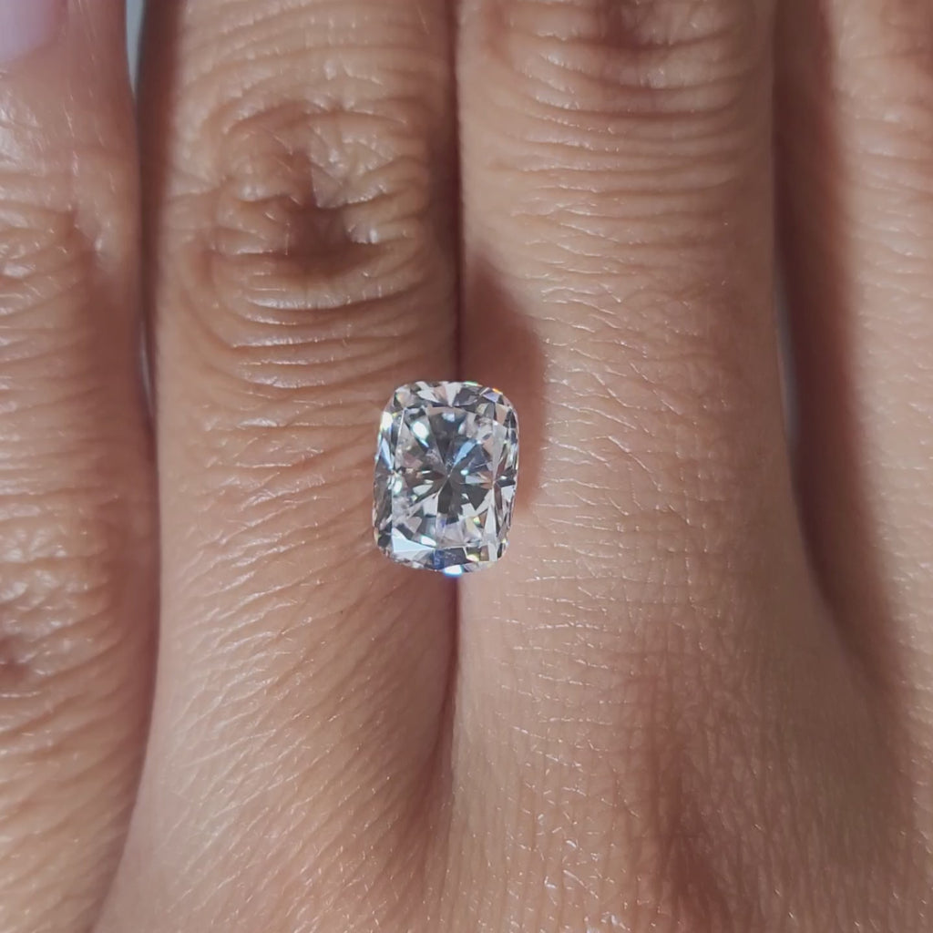 "Hand-modeled video of 2.166ct cushion diamond in warm indoor lighting"