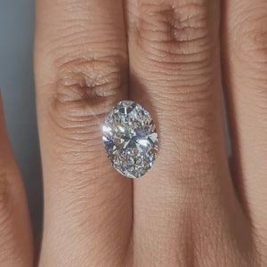 Hand-display video showing 3.51ct oval diamond in warm interior light