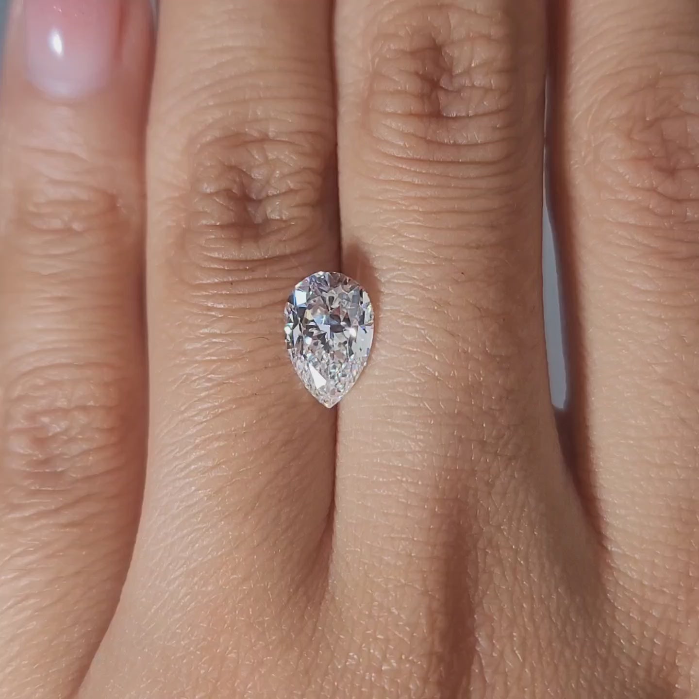 Hand modeling video showing pear diamond's size