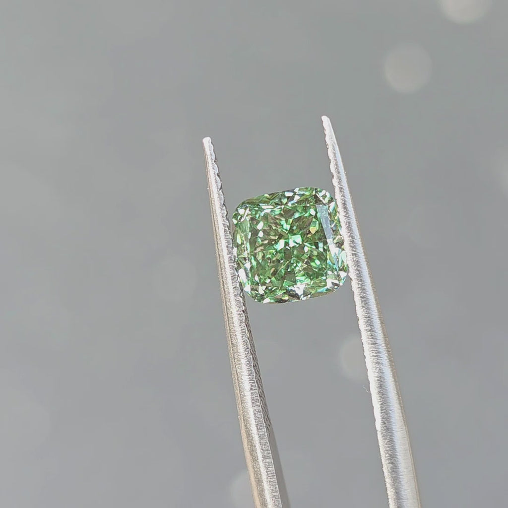 Sunlight reveals the vibrant green of a 2.07ct cushion brilliant cut fancy vivid green VVS2 lab diamond.