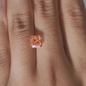 Hand-worn video of 1.535ct pink-orange diamond in warm indoor light