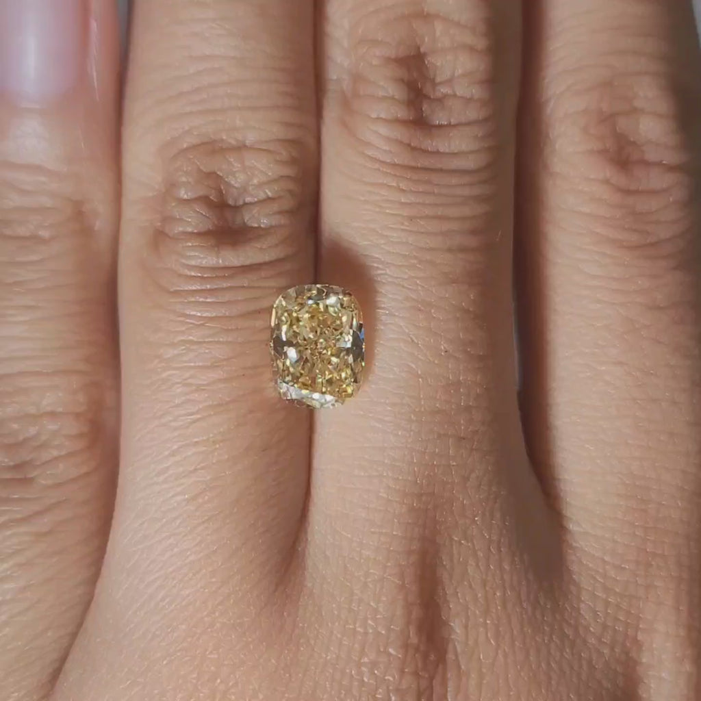 2.4ct yellow cushion cut lab diamond video under warm lighting, VVS2 clarity