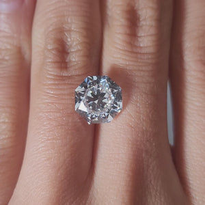 "Hand-modeled video of 4.010ct octagon diamond in warm indoor lighting"