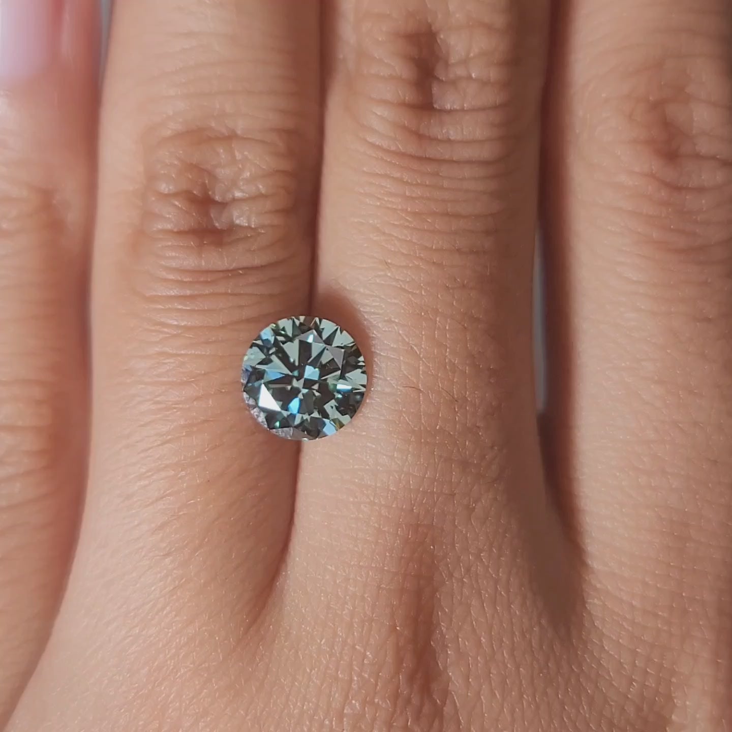 "Comparison video showing 2.00ct green diamond's color shift in different lighting"