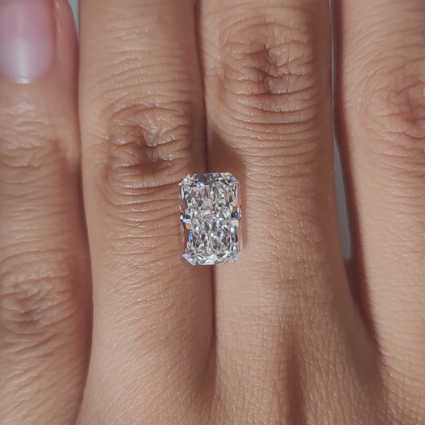 Hand-worn video of 3.290ct radiant diamond in warm interior lighting