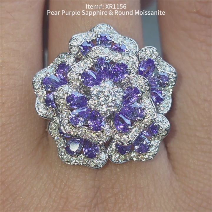 DovEggs pear purple sapphire & round cut moissanite ring sparkling in sunlight video.