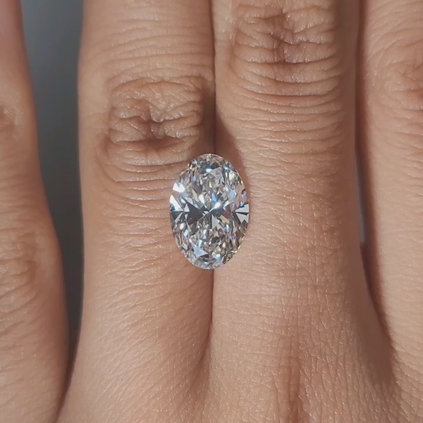 Hand-worn video of 3.37ct oval diamond in warm interior lighting