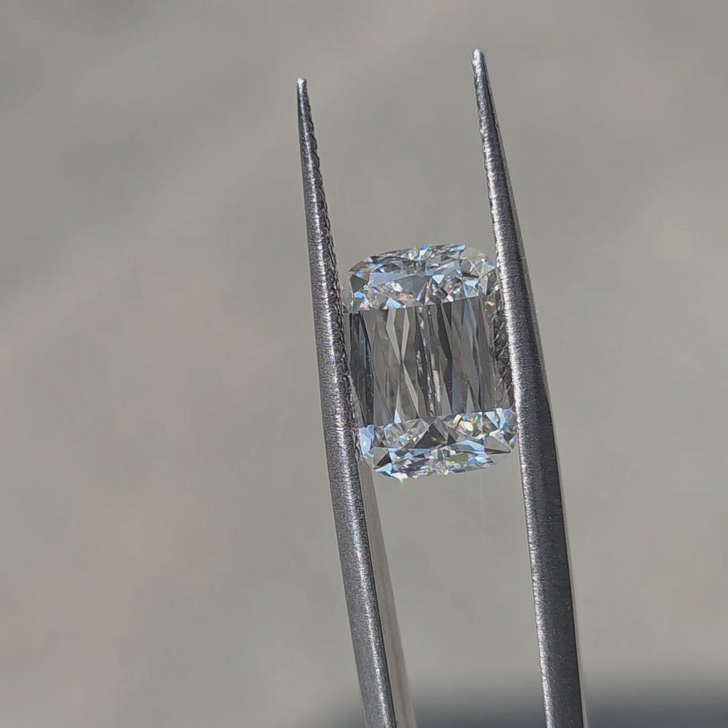 A 5.07ct elongated cushion brilliant cut lab diamond shines in outdoor sunlight.