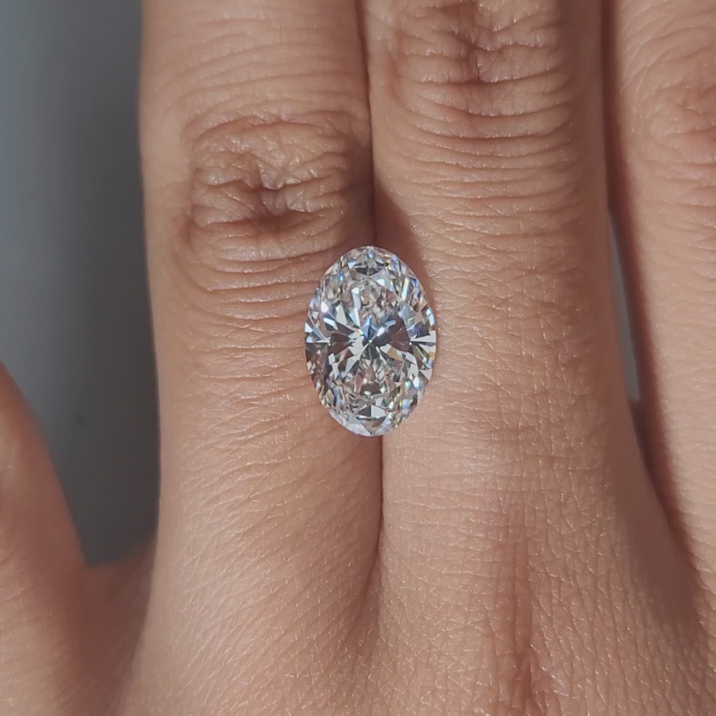 Hand-modeled video of 3.18ct oval diamond in warm interior lighting