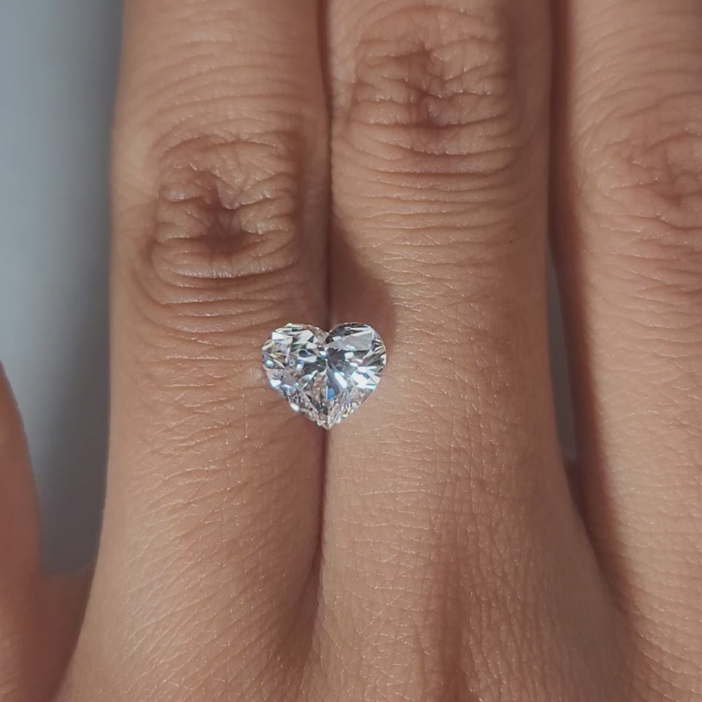 Close-up hand video showcasing 1.60ct heart diamond in soft indoor light