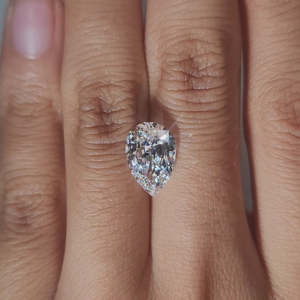 Close-up hand video of 3.032ct pear diamond in soft indoor lighting