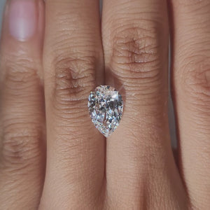 Close-up hand video of 3.032ct pear diamond in soft indoor lighting