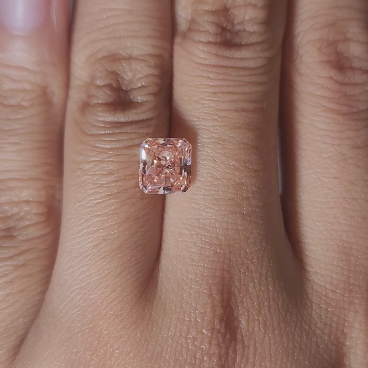 video showing 2.02ct pink diamond's facet precision under warm lighting