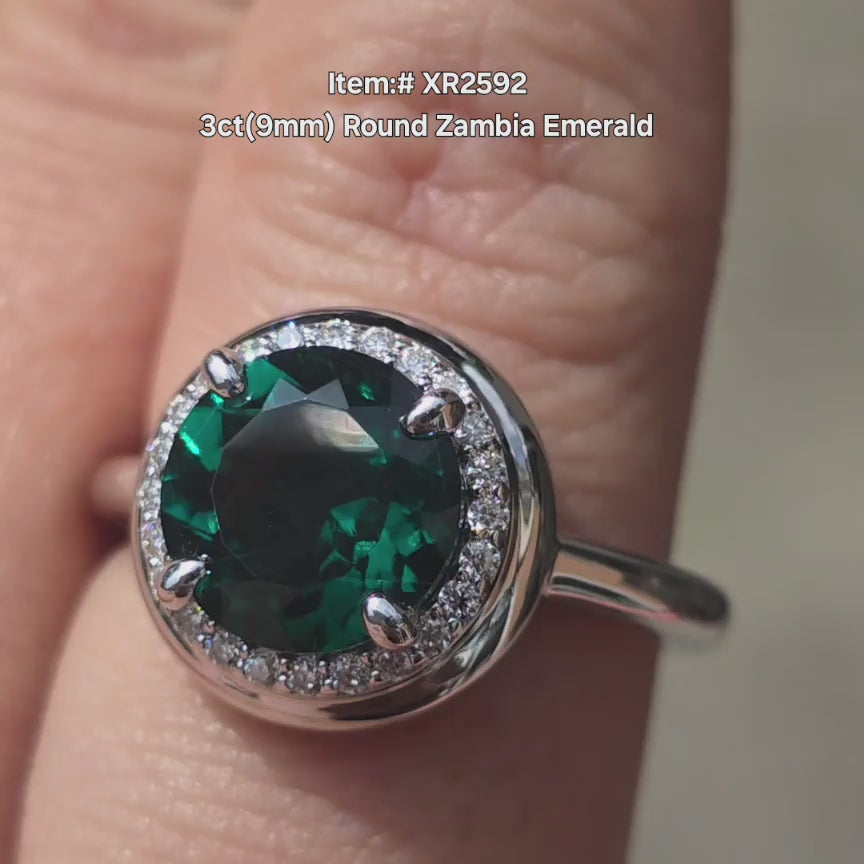 DovEggs round Zambia Emerald engagement  ring sparkling in sunlight video.