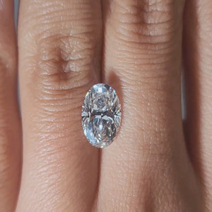 "Hand-modeled video of 2.252ct oval diamond in warm indoor lighting"