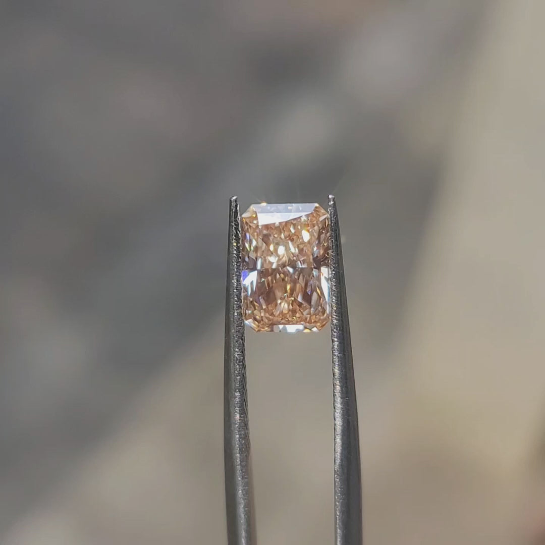 Natural daylight video capturing 2.23ct radiant cut's pink hue variations