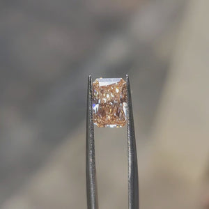 Natural daylight video capturing 2.23ct radiant cut's pink hue variations