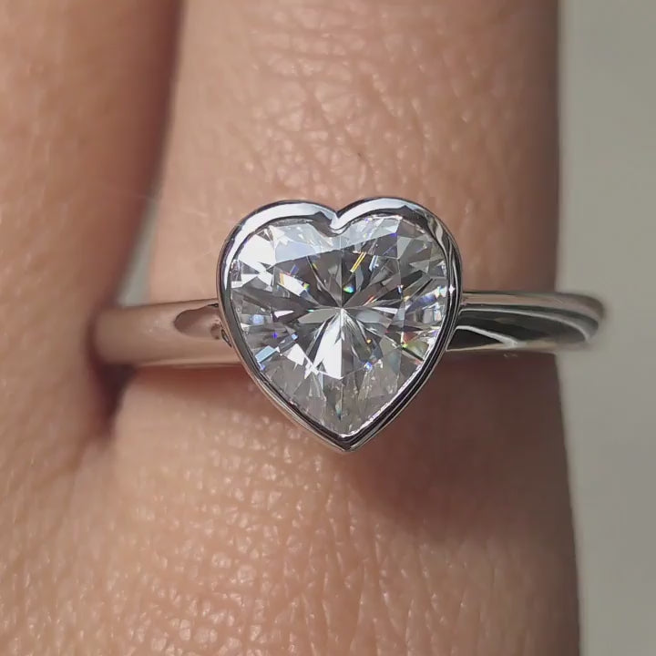 DovEggs heart moissanite engagement ring sparkling in sunlight video.